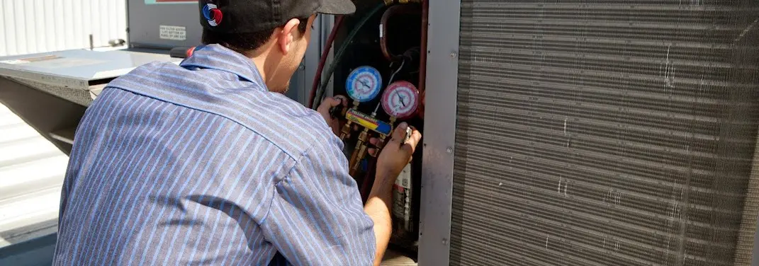 HVAC technician servicing a condenser unit in North Myrtle Beach