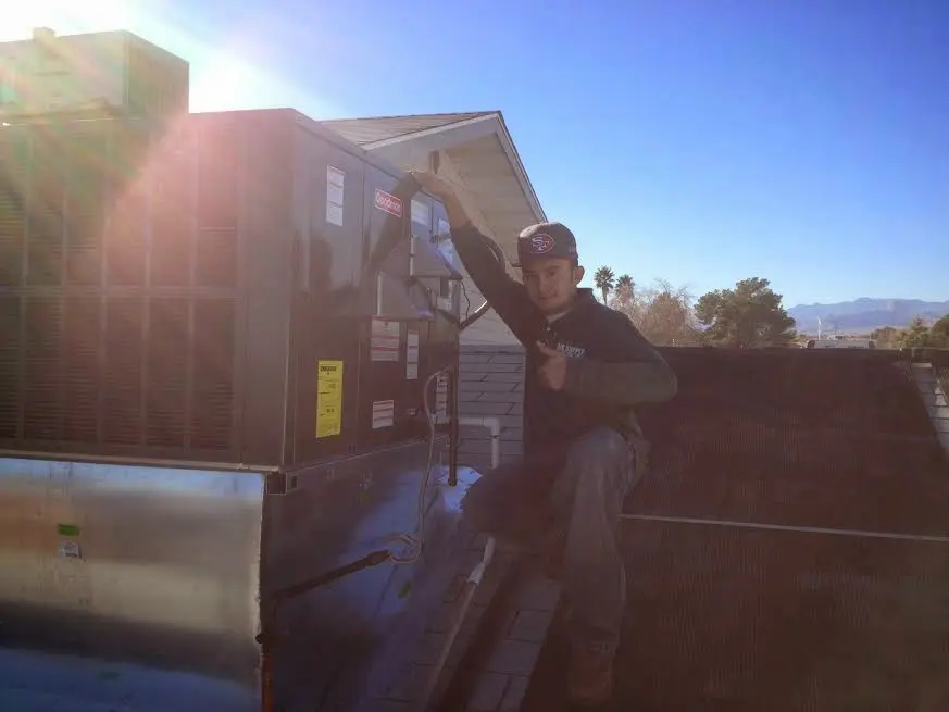 HVAC technician performing HVAC Inspection on a rooftop unit in North Myrtle Beach